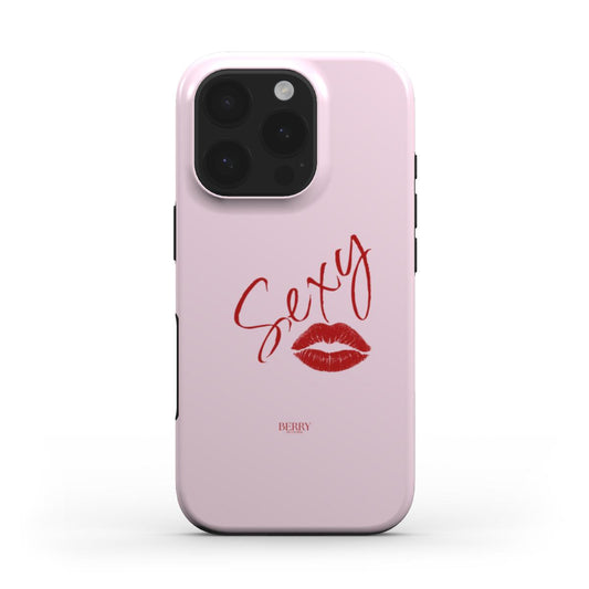 Trendy pink phone case with red handwritten "Sexy" text and kiss mark, featuring a feminine and girly aesthetic in stylish pink and red colors.
