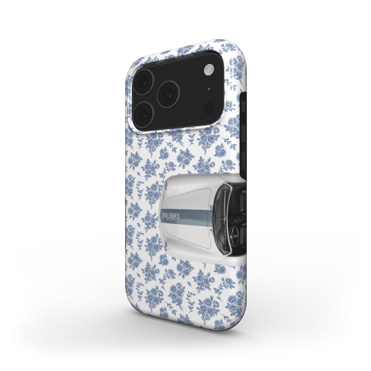 Trendy feminine phone case with a stylish white, multicolored, and blue floral pattern paired with a sleek vintage car design for a beautiful girly look.