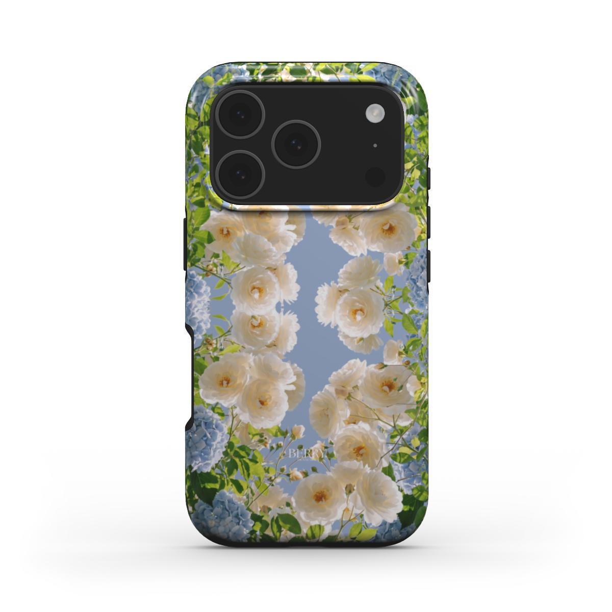 Trendy feminine phone case with multicolored floral pattern featuring white, blue, and beige blooms against a soft blue background for a beautiful spring vibe.
