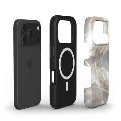 Black phone case with magnetic ring and elegant beige, white, and multicolored marbled phone case showcasing a trendy and feminine design.