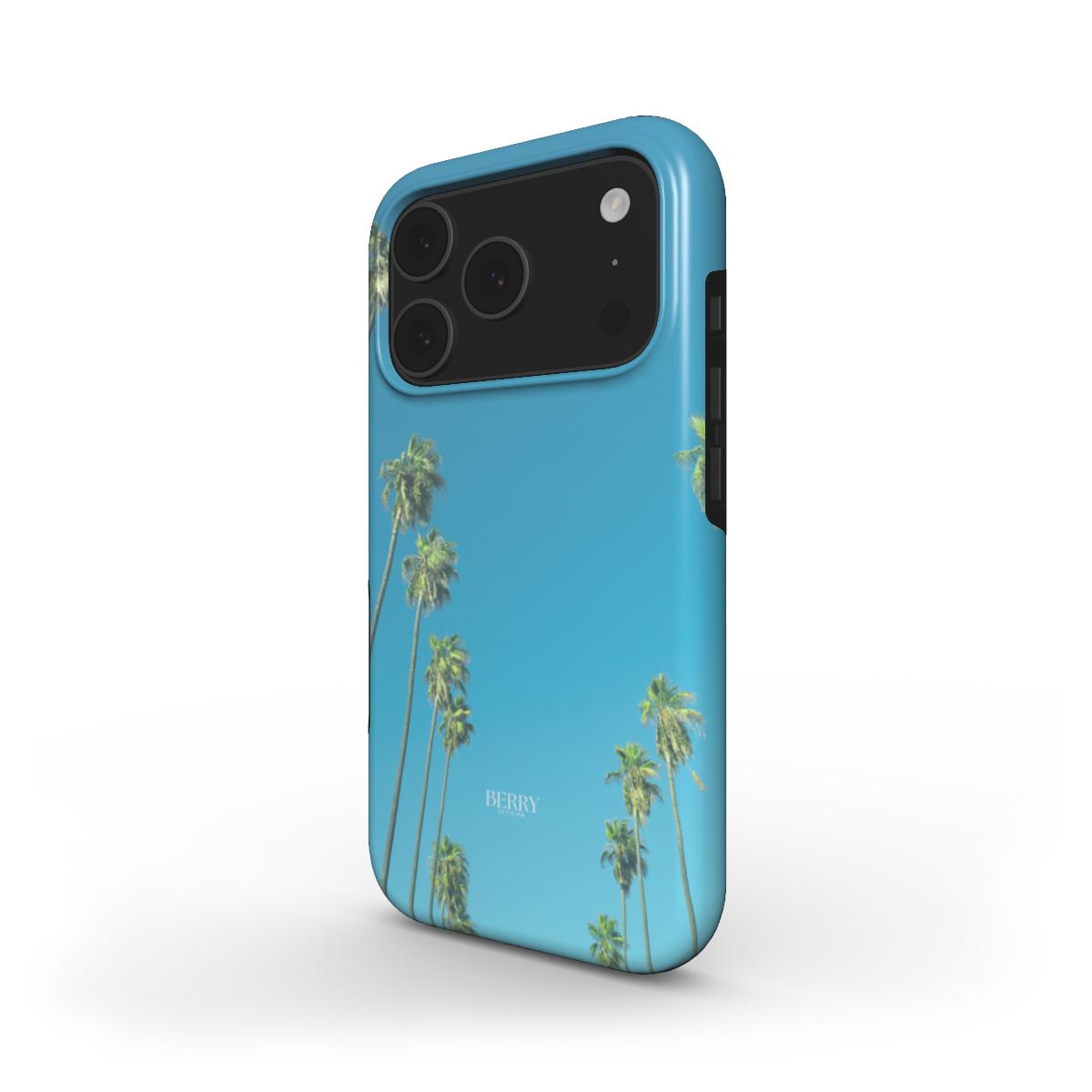 Trendy phone case with a multicolor palm tree design against a vibrant blue background, perfect for a stylish and feminine aesthetic.