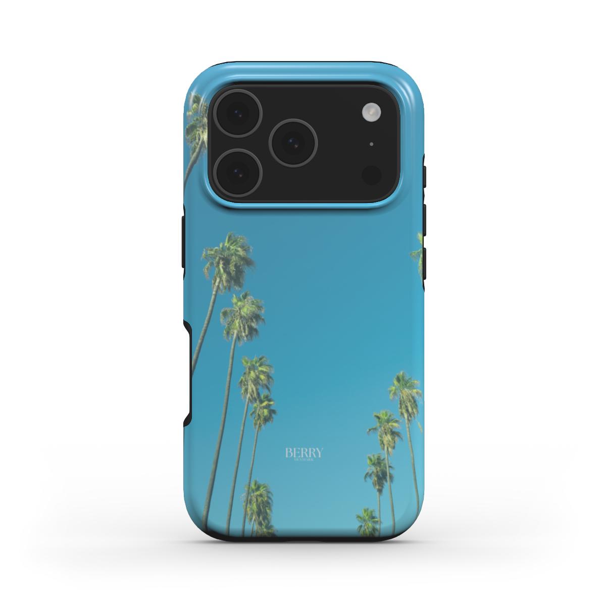 Trendy phone case with a colorful blue background and tall palm trees, offering a feminine and popular aesthetic perfect for that girl look.
