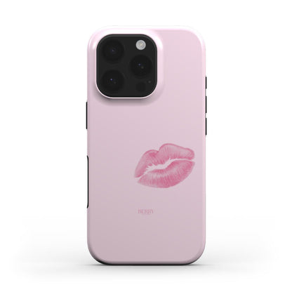 Trendy pink phone case with a feminine lip print design, featuring a subtle multicolored pattern for a stylish and girly look.