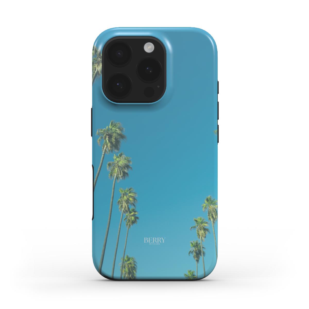 Trendy phone case with flerfarvet palm tree design against clear blue sky, offering a beautiful, girly, and aesthetic style perfect for that girl vibe.