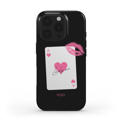 Black phone case with a pink and multicolored ace of hearts card design and a pink lipstick kiss detail, creating a trendy feminine look.